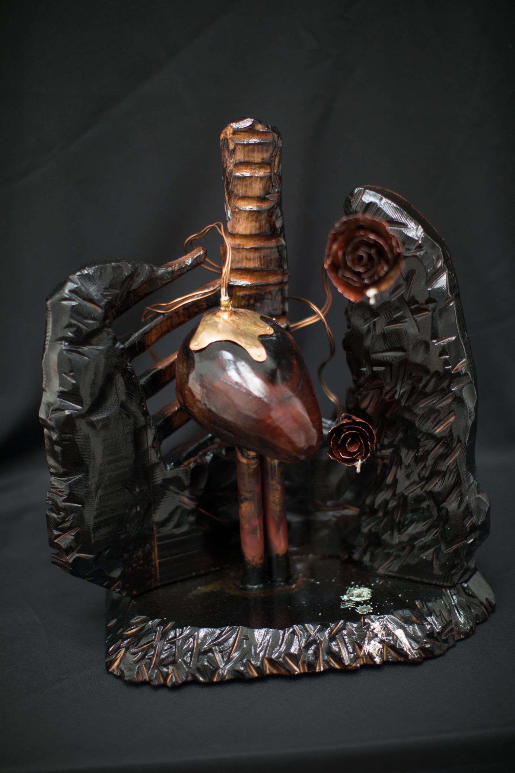 Valentine sculpture of a metal heart surrounded by lungs and a spine